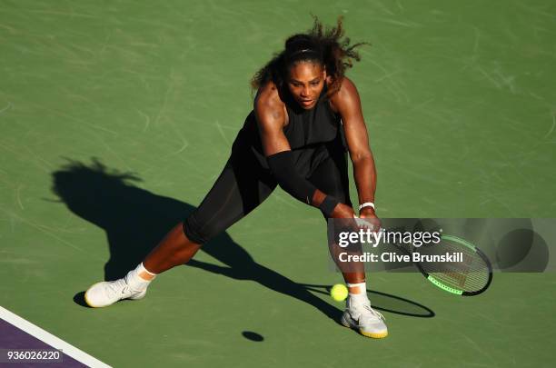Serena Williams of the United States plays a backhand against Naomi Osaka of Japan in their first round match during the Miami Open Presented by Itau...