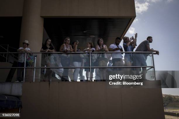 Tourist uses mobile devices to take photographs of the Panama Canal's Miraflores Locks in Panama City, Panama, on Sunday, Feb. 25, 2018. Panama's...