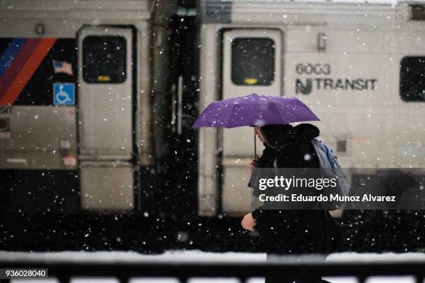 Man walks at the Hoboken train terminal during a snow storm on March 21, 2018 in Hoboken, New Jersey. At least 12 to 15 inches are expected in parts...