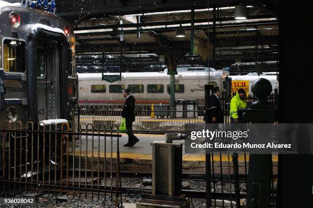 People walk at the Hoboken train terminal during a snow storm on March 21, 2018 in Hoboken, New Jersey. At least 12 to 15 inches are expected in...