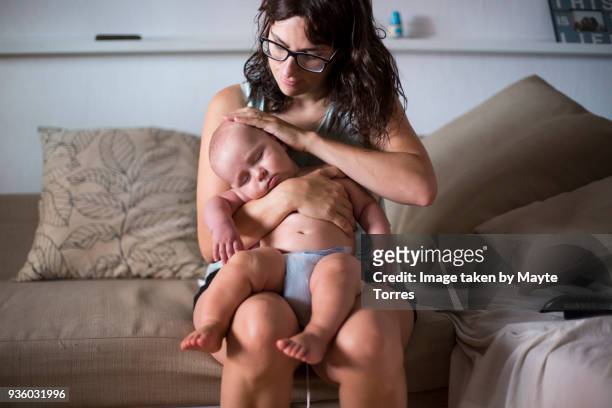 baby boy asleep on top of mom - hot spanish women stock pictures, royalty-free photos & images