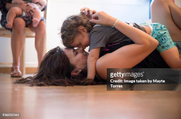 mother and toddler lying on the floor playing - hot spanish women stock pictures, royalty-free photos & images