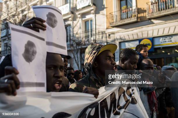 Men with pictures of Mmame Mbaye, a Senegalese street vendor who died of cardiac arrest, supposedly during a police raid. The Senegalese community...