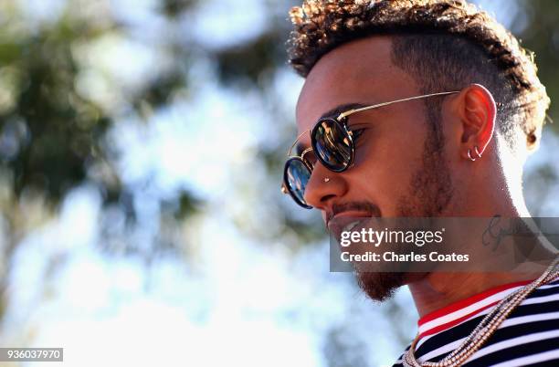 Lewis Hamilton of Great Britain and Mercedes GP arrives at the circuit during previews ahead of the Australian Formula One Grand Prix at Albert Park...