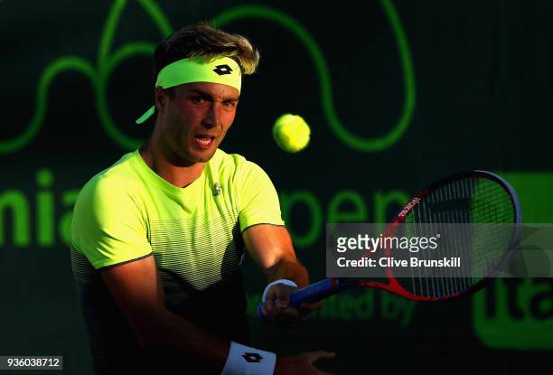 Liam Broady of Great Britain plays a forehand against Bjorn Fratangelo of the United States in their first round match during the Miami Open...