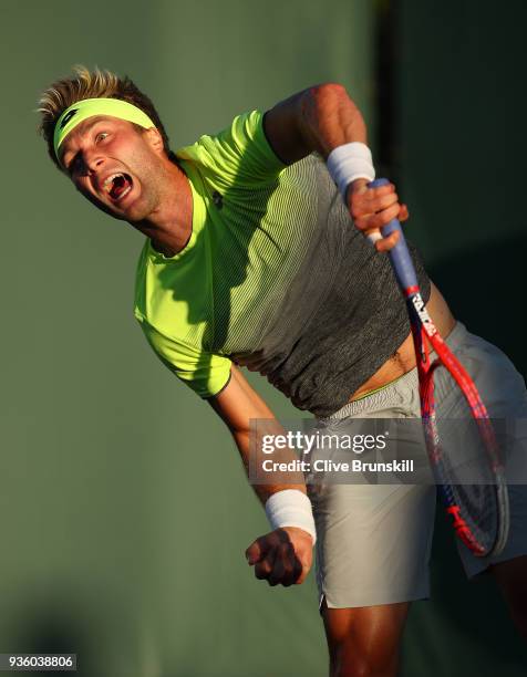 Liam Broady of Great Britain serves against Bjorn Fratangelo of the United States in their first round match during the Miami Open Presented by Itau...