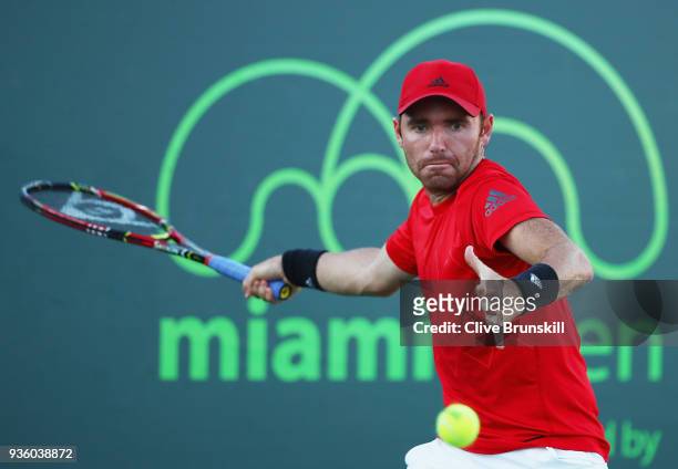Bjorn Fratangelo of the United States plays a forehand against Liam Broady of Great Britain in their first round match during the Miami Open...