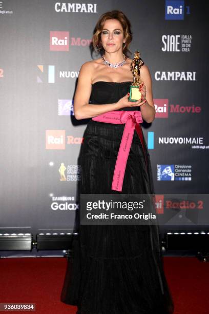 Claudia Gerini poses with the Best Supporting Actress Award at the end of the 62nd David Di Donatello awards ceremony on March 21, 2018 in Rome,...