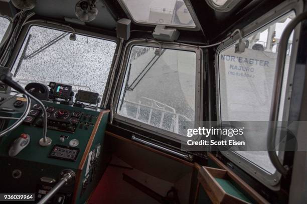 Waves crash over the windows of the pilot boat "Chelsea" as it drives close behind the stern of the oil tanker "Nor'Easter," to avoid large waves as...