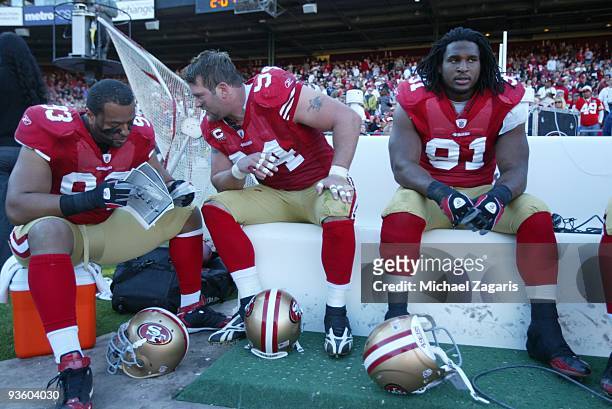 Demetric Evans, Justin Smith and Ray McDonald of the San Francisco 49ers on the bench during the NFL game against the Jacksonville Jaguars at...