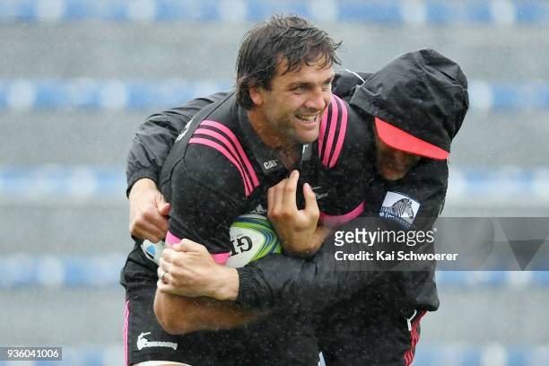 Heiden Bedwell-Curtis is tackled by Head Coach Scott Robertson during the Crusaders Super Rugby captain's run at AMI Stadium on March 22, 2018 in...