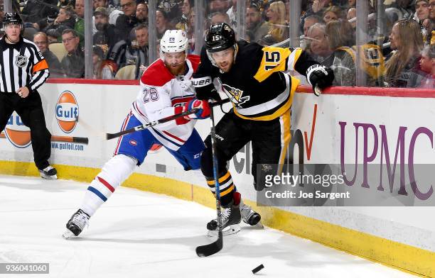 Riley Sheahan of the Pittsburgh Penguins handles the puck against Jeff Petry of the Montreal Canadiens at PPG Paints Arena on March 21, 2018 in...