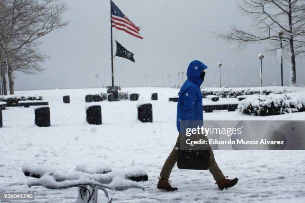 Man walks during a snow storm on March 21, 2018 in Hoboken, New Jersey. At least 12 to 15 inches are expected in parts of Westchester, New York, New...