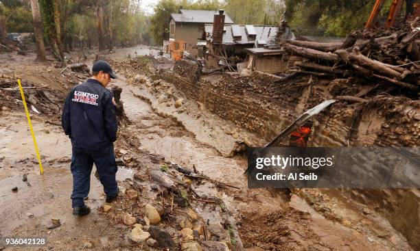 Lompoc Firefighter Chris Martinez who is with a Search and Rescue Regional Task Force scouts Montecito Creek at the East Valley Road crossing near...