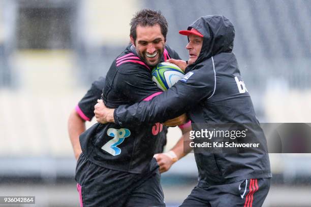 Captain Samuel Whitelock is tackled by Head Coach Scott Robertson during the Crusaders Super Rugby captain's run at AMI Stadium on March 22, 2018 in...