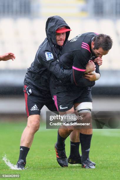 Captain Samuel Whitelock is tackled by Head Coach Scott Robertson during the Crusaders Super Rugby captain's run at AMI Stadium on March 22, 2018 in...