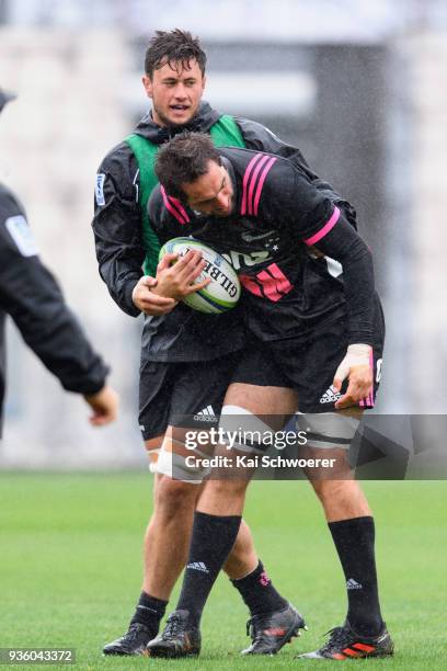 Samuel Whitelock is tackled by Quinten Strange during the Crusaders Super Rugby captain's run at AMI Stadium on March 22, 2018 in Christchurch, New...