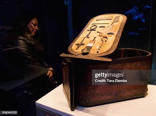 Guest views an Inlaid Wooden Cartouche Box on display during the official media preview for the world premiere of 'King Tut: Treasures Of The Golden...