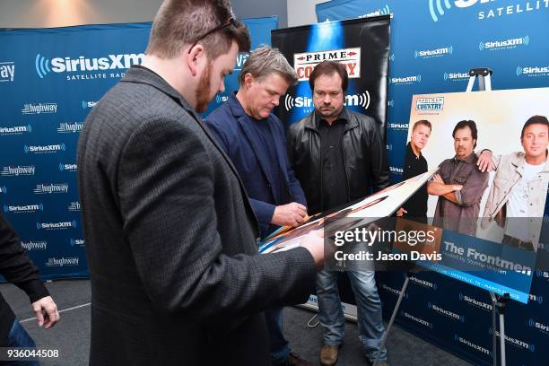 Recording Artists Richie McDonald of The Frontmen signs a poster at SiriusXM Nashville Studios at Bridgestone Arena on March 21, 2018 in Nashville,...