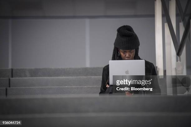 An attendee uses an Apple Inc. Laptop computer during the Game Developers Conference in San Francisco, California, U.S., on Wednesday, March 21,...