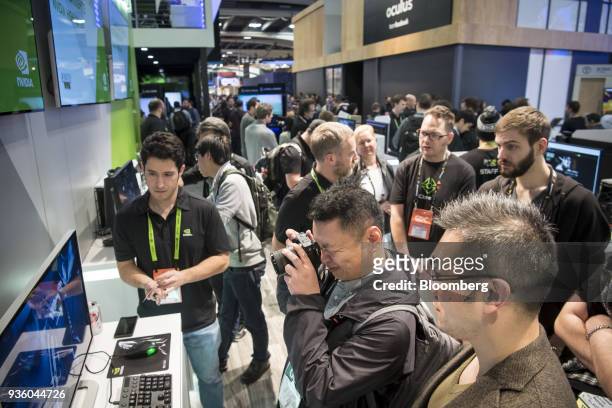 Attendees view a display monitor at the Nvidia Corp. Booth during the Game Developers Conference in San Francisco, California, U.S., on Wednesday,...