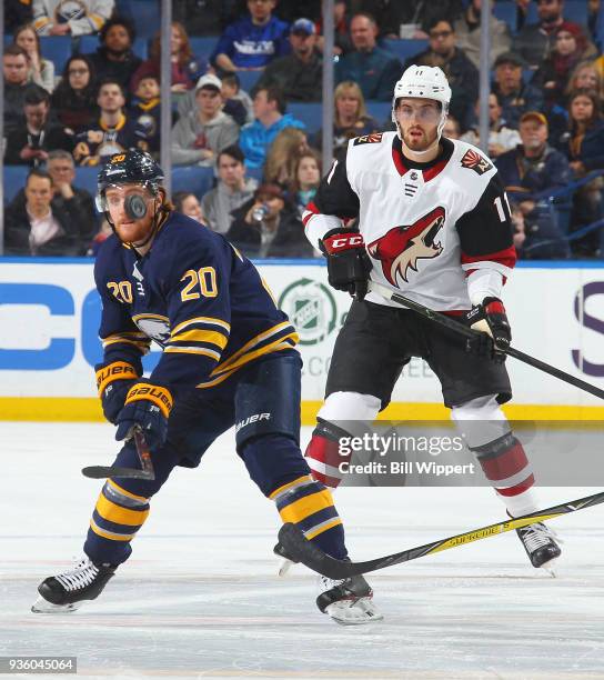 Scott Wilson of the Buffalo Sabres looks to control the puck against Brendan Perlini of the Arizona Coyotes during an NHL game on March 21, 2018 at...