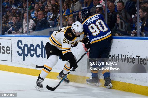 Adam McQuaid of the Boston Bruins checks Nikita Soshnikov of the St. Louis Blues at Scottrade Center on March 21, 2018 in St. Louis, Missouri.