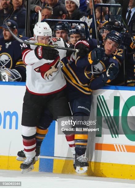 Josh Archibald of the Arizona Coyotes checks Johan Larsson of the Buffalo Sabres during an NHL game on March 21, 2018 at KeyBank Center in Buffalo,...