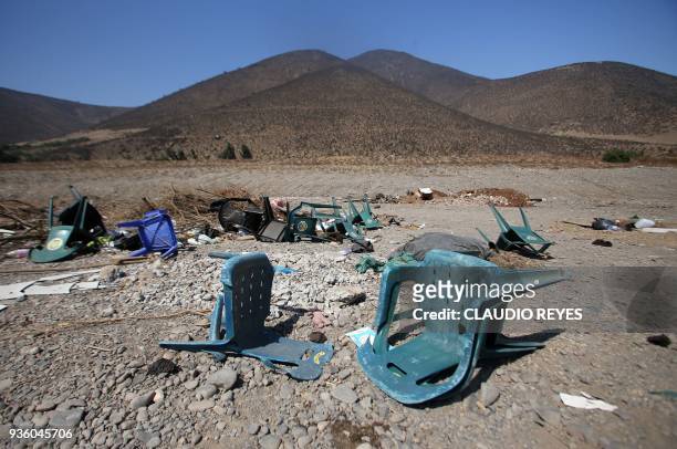 Plastic chairs and other garbage are seen in the dry riverbed of the La Ligua river, in La Ligua, province of Petorca, Valparaiso Region, Chile, on...
