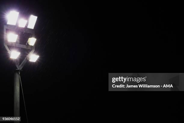 Rain falls against a floodlight during the Sky Bet League One match between Wigan Athletic and Walsall at Banks' Stadium on March 23, 2018 in...