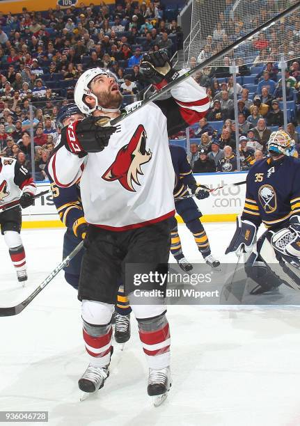 Jordan Martinook of the Arizona Coyotes reaches for the puck during an NHL game against the Buffalo Sabres on March 21, 2018 at KeyBank Center in...