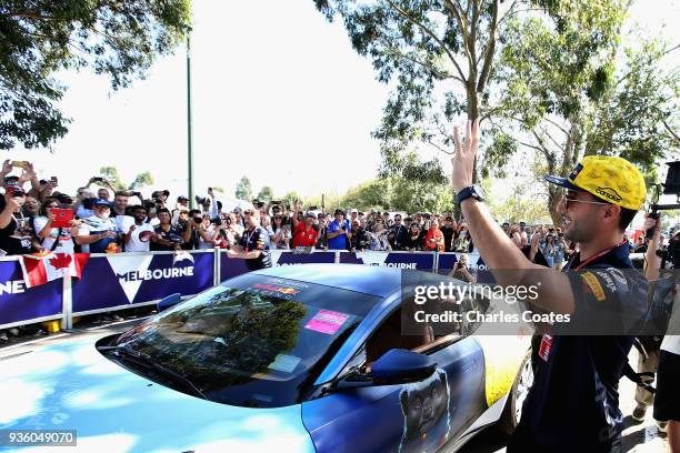 Daniel Ricciardo of Australia and Red Bull Racing arrives at the circuit and waves to fans during previews ahead of the Australian Formula One Grand...