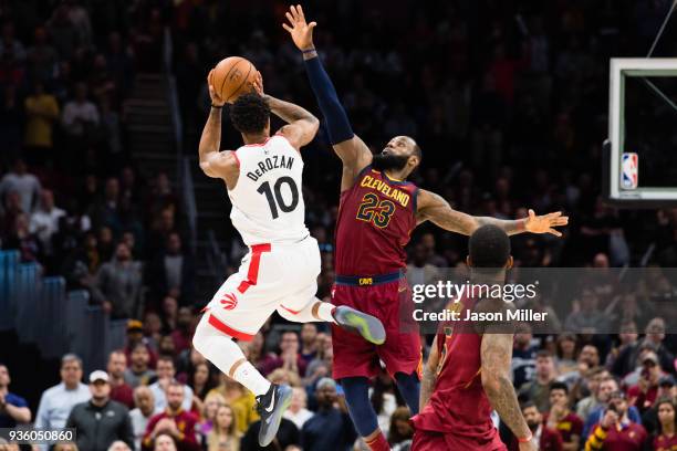 DeMar DeRozan of the Toronto Raptors tries to take a last second shot over LeBron James of the Cleveland Cavaliers during the second half at Quicken...
