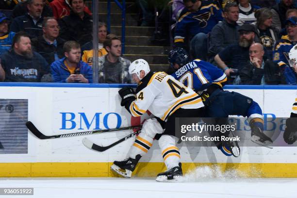 Nick Holden of the Boston Bruins checks Vladimir Sobotka of the St. Louis Blues at Scottrade Center on March 21, 2018 in St. Louis, Missouri.