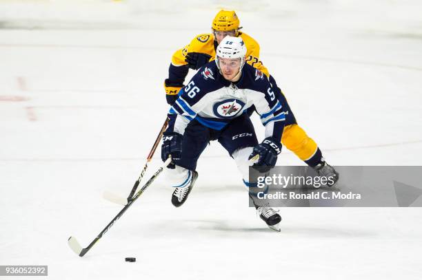 Marko Dano of the Winnipeg Jets skates against Kevin Fiala of the Nashville Predators during an NHL game at Bridgestone Arena on March 13, 2018 in...
