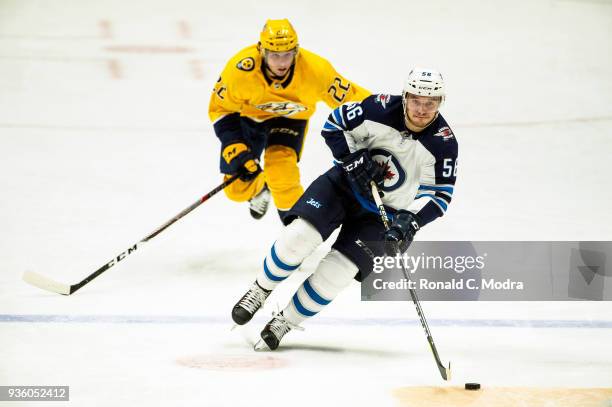 Marko Dano of the Winnipeg Jets skates against Kevin Fiala of the Nashville Predators during an NHL game at Bridgestone Arena on March 13, 2018 in...