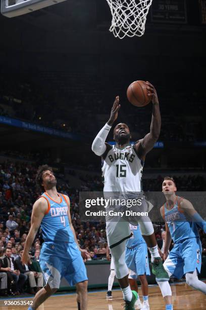 Shabazz Muhammad of the Milwaukee Bucks shoots against Milos Teodosic and Sam Dekker of the Los Angeles Clippers during the NBA game on March 21,...