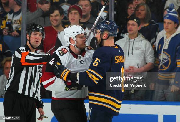 Niklas Hjalmarsson of the Arizona Coyotes and Marco Scandella of the Buffalo Sabres have words during an NHL game on March 21, 2018 at KeyBank Center...