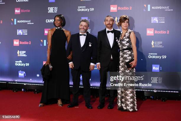 Juliet Esey Joseph, Antonio Manetti, Marco Manetti and his wife walk a red carpet ahead of the 62nd David Di Donatello awards ceremony on March 21,...