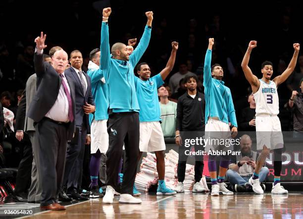 The Charlotte Hornets bench celebrates late in the fourth quarter against the Brooklyn Nets during their game at Barclays Center on March 21, 2018 in...