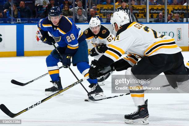 Vince Dunn of the St. Louis Blues controls the puck against Tommy Wingels of the Boston Bruins at Scottrade Center on March 21, 2018 in St. Louis,...