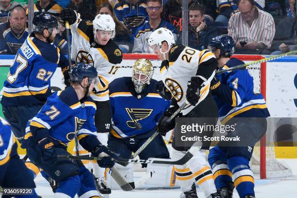 Jake Allen of the St. Louis Blues and Alex Pietrangelo of the St. Louis Blues defend the net against Ryan Donato of the Boston Bruins and Alexander...