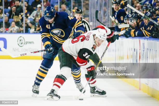 Arizona Coyotes Right Wing Christian Fischer shields puck from Buffalo Sabres Defenseman Justin Falk during the Arizona Coyotes and Buffalo Sabres...