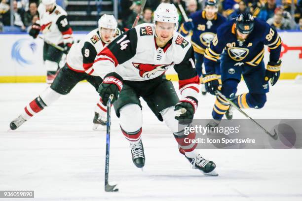 Arizona Coyotes Left Wing Richard Panik skates with the puck as Arizona Coyotes Winger Clayton Keller and Buffalo Sabres Center Ryan O'Reilly trail...