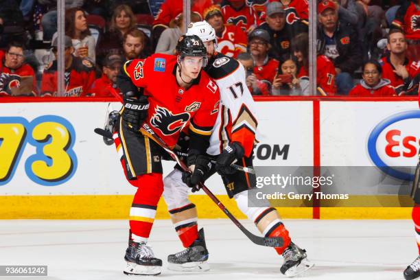 Sean Monahan of the Calgary Flames and Ryan Kesler of the Anaheim Ducks battle for position in an NHL game on March 21, 2018 at the Scotiabank...