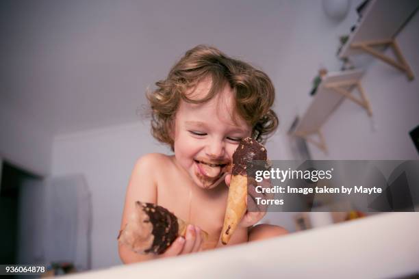 toddler excited eating two icecreams - candy on tongue stock pictures, royalty-free photos & images
