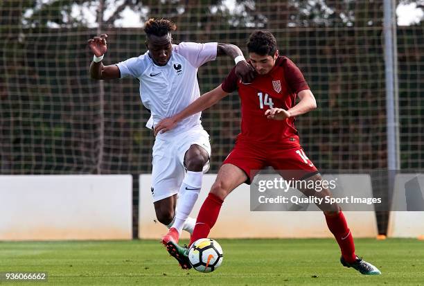 Yann Karamoh of France competes for the ball with Manny Perez of USA during the international friendly match between France U20 and USA U20 at...