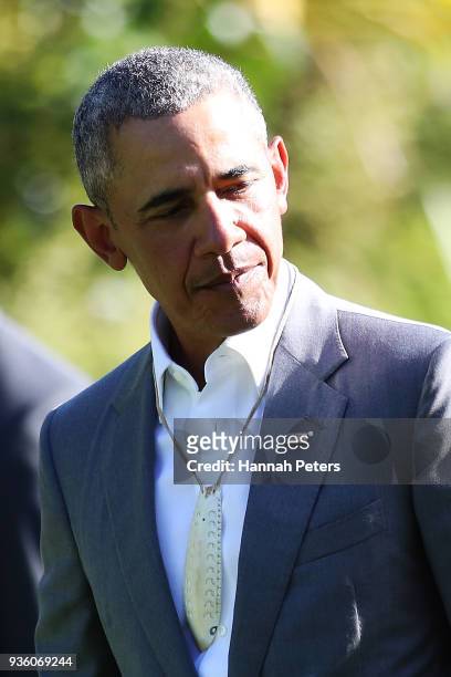 Barack Obama wears a carved whale tooth gifted to him after attending a powhiri at Government House on March 22, 2018 in Auckland, New Zealand. It is...