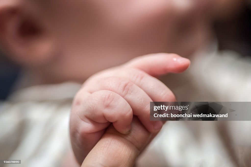 Holding baby hand