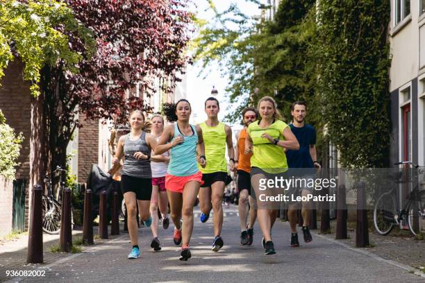 urban runners crew training in the city - center athlete stock pictures, royalty-free photos & images